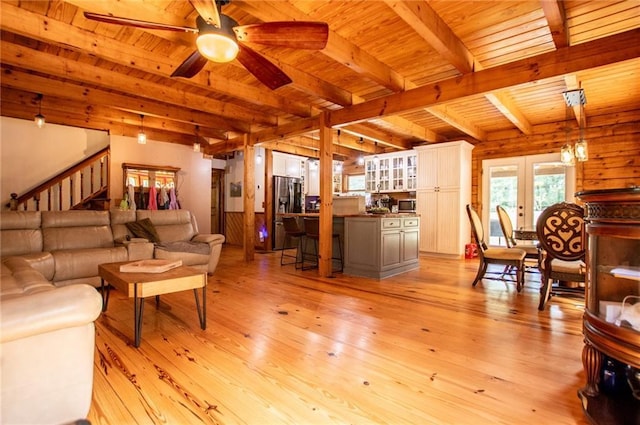 living room with wooden ceiling, light wood-type flooring, and beam ceiling