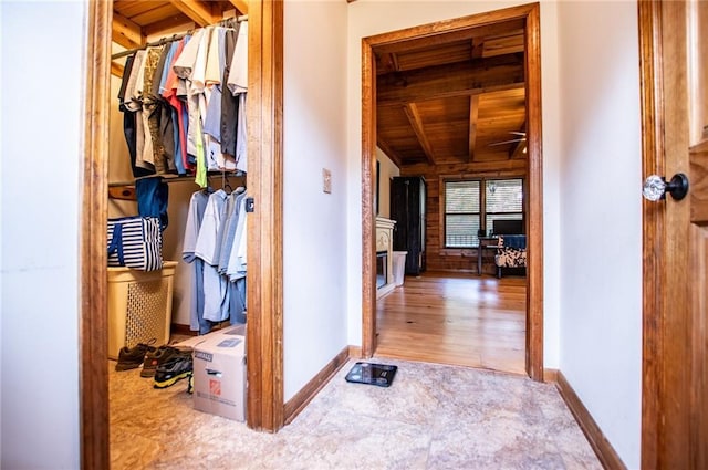 hall with baseboards and wood ceiling