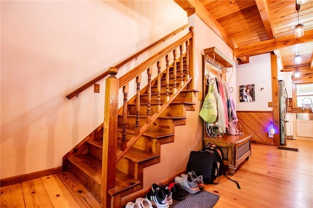 stairs with beamed ceiling, wooden ceiling, wood finished floors, and radiator