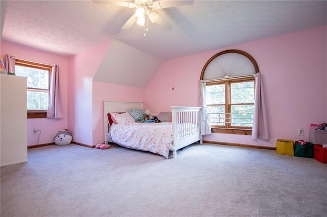 bedroom featuring baseboards, carpet flooring, a ceiling fan, and vaulted ceiling