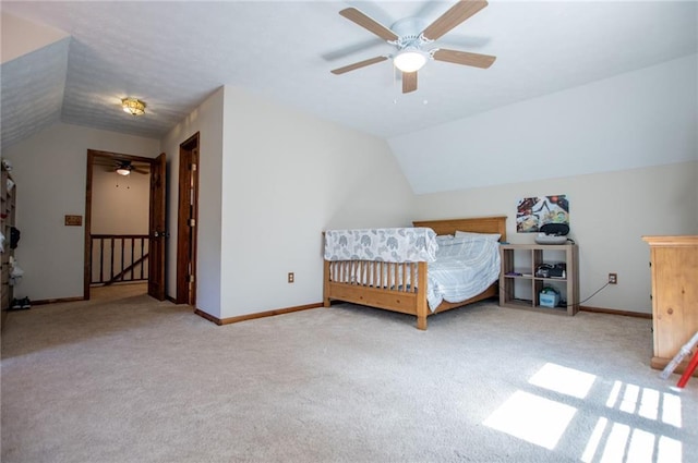 carpeted bedroom with baseboards, a ceiling fan, and vaulted ceiling