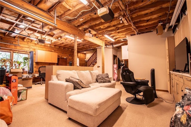 below grade area with carpet floors, wood walls, and stairs