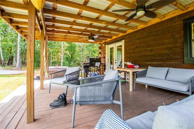 wooden terrace with an outdoor living space, ceiling fan, french doors, and a covered hot tub