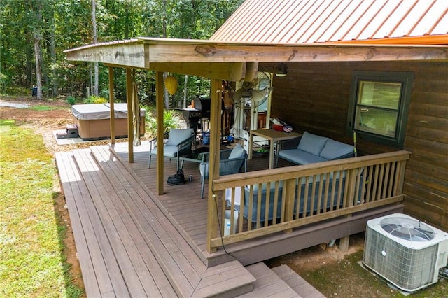 deck featuring a hot tub, grilling area, and central air condition unit