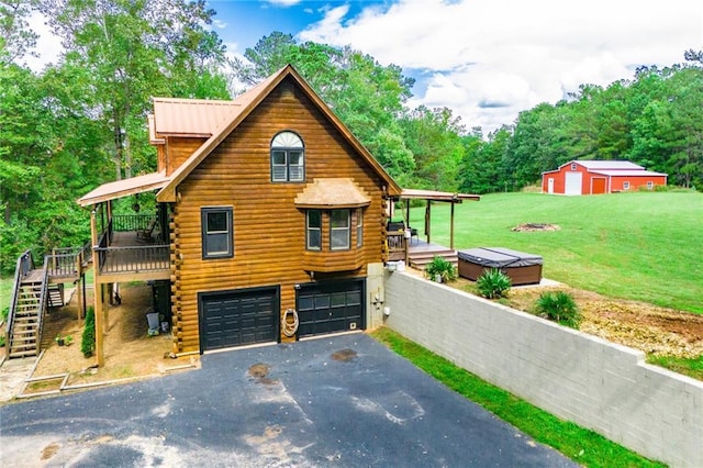 view of front of property with a front yard, a deck, log exterior, an attached garage, and driveway