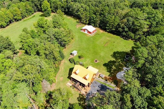 drone / aerial view with a wooded view