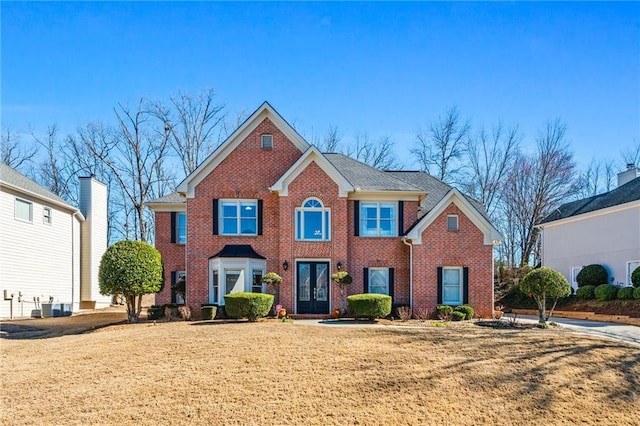 view of front of property with a front yard and french doors