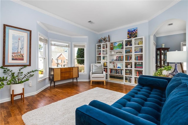 living area featuring crown molding and dark hardwood / wood-style flooring