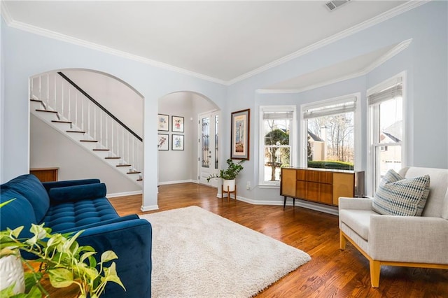 living room featuring hardwood / wood-style flooring and crown molding