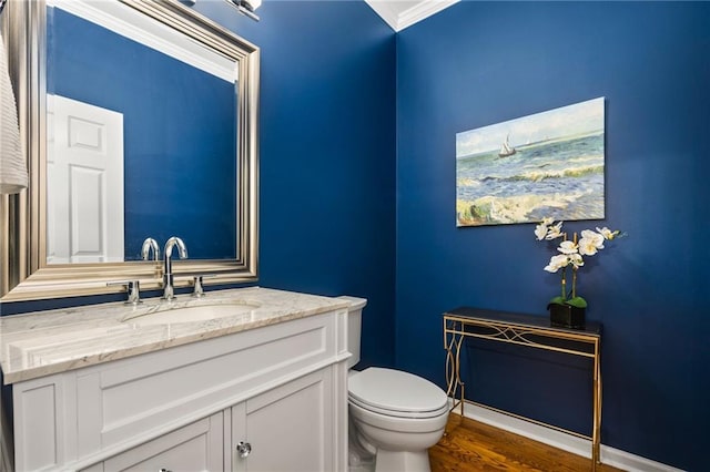 bathroom featuring hardwood / wood-style flooring, toilet, and vanity