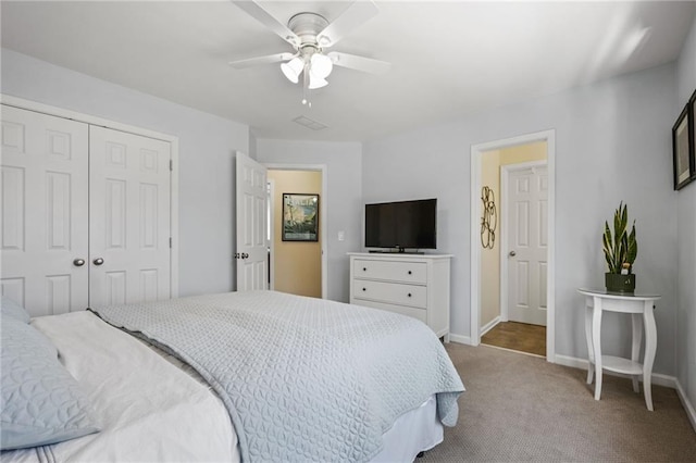 carpeted bedroom featuring a closet and ceiling fan