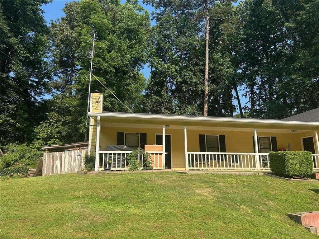 2128 Valley Oaks Dr, Smyrna, GA 30080 - view of front of home featuring a porch, a front yard, and a chimney