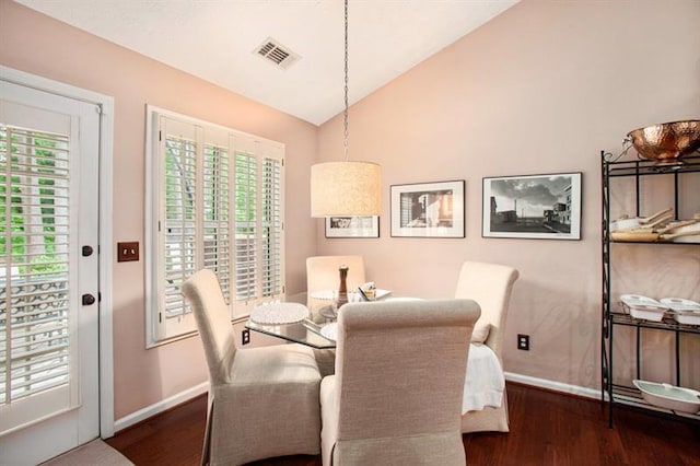 dining room with dark hardwood / wood-style floors and vaulted ceiling