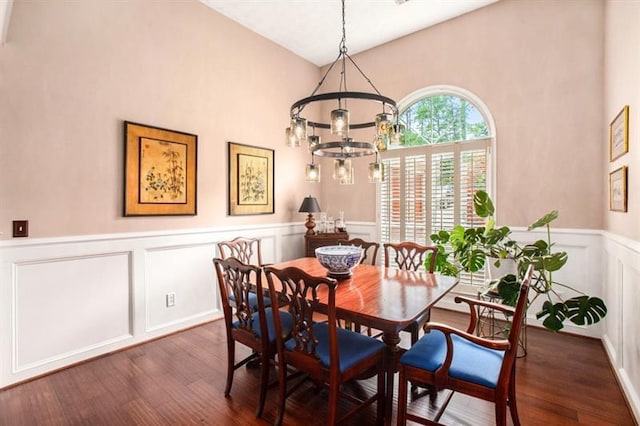 dining room with a notable chandelier, dark hardwood / wood-style floors, and high vaulted ceiling