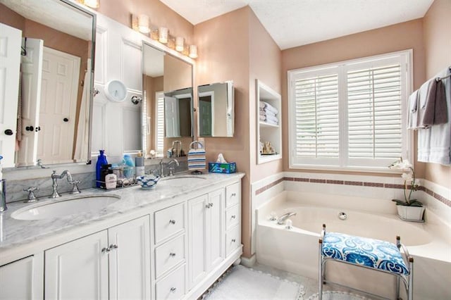 bathroom featuring vanity and a tub