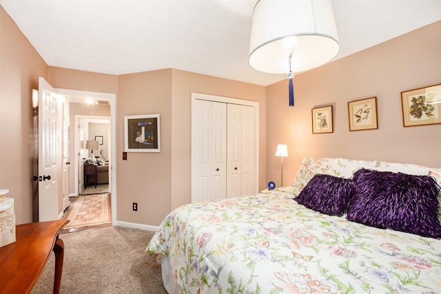 bedroom featuring light colored carpet and a closet