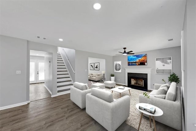 living room featuring hardwood / wood-style floors, ceiling fan, and french doors