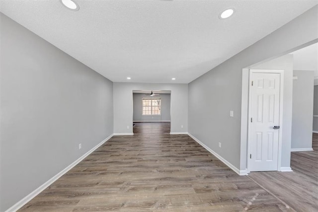 empty room with hardwood / wood-style flooring and a textured ceiling