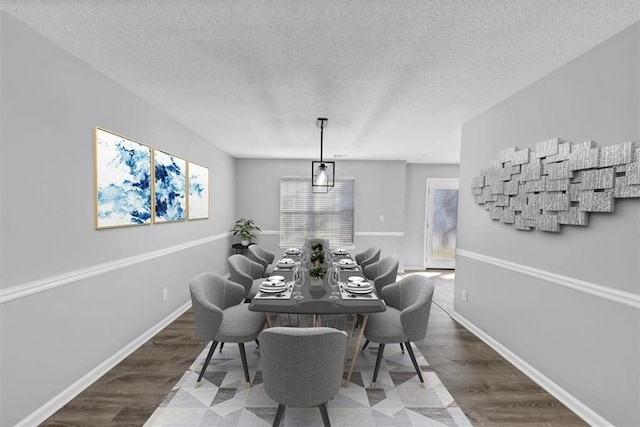 dining area featuring dark hardwood / wood-style floors and a textured ceiling