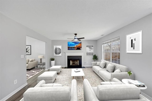 living room with wood-type flooring and ceiling fan