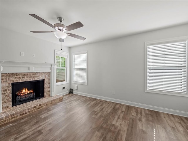 385 Finch Landing Rd, Winder, GA 30680 - unfurnished living room featuring wood finished floors, ceiling fan, a fireplace, and baseboards
