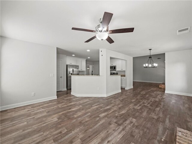 385 Finch Landing Rd, Winder, GA 30680 - unfurnished living room featuring visible vents, ceiling fan with notable chandelier, baseboards, and dark wood finished floors