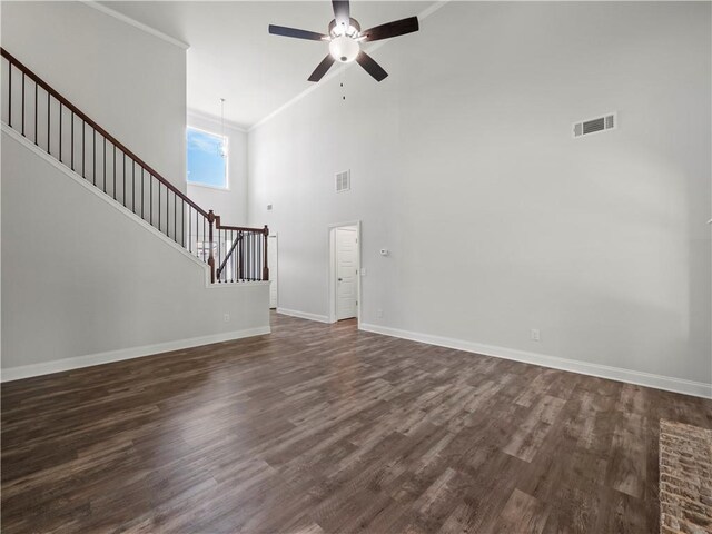 385 Finch Landing Rd, Winder, GA 30680 - unfurnished living room with dark wood-style flooring, a ceiling fan, visible vents, and stairs