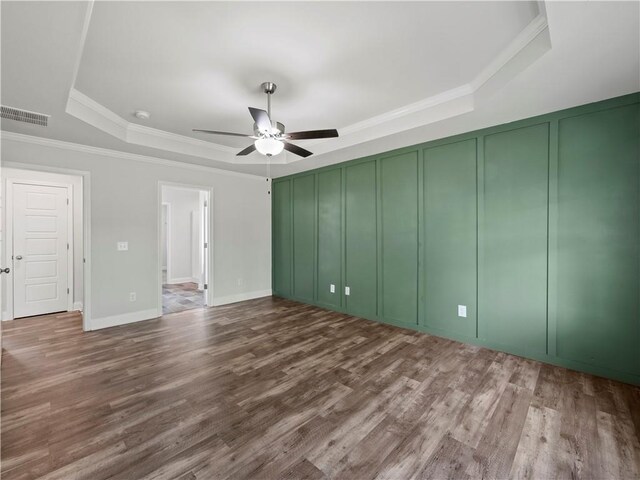 385 Finch Landing Rd, Winder, GA 30680 - interior space with visible vents, a raised ceiling, a decorative wall, a ceiling fan, and wood finished floors