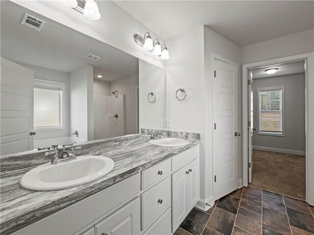 385 Finch Landing Rd, Winder, GA 30680 - full bath with a sink, visible vents, and baseboards