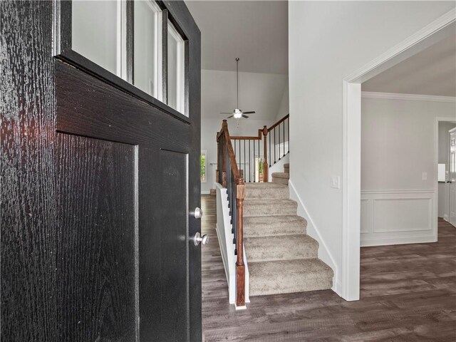 385 Finch Landing Rd, Winder, GA 30680 - foyer entrance featuring crown molding, ceiling fan, a wainscoted wall, stairway, and wood finished floors