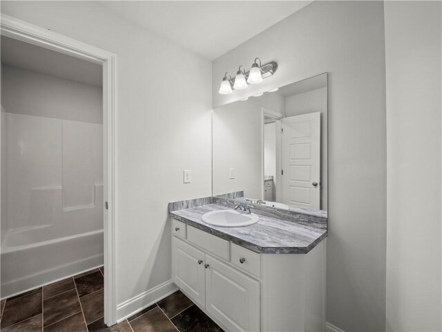 385 Finch Landing Rd, Winder, GA 30680 - bathroom featuring shower / bath combination, vanity, and baseboards