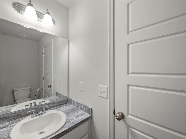 385 Finch Landing Rd, Winder, GA 30680 - half bath with toilet, vanity, and visible vents