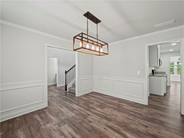 385 Finch Landing Rd, Winder, GA 30680 - unfurnished dining area featuring a chandelier, dark wood finished floors, ornamental molding, and stairway
