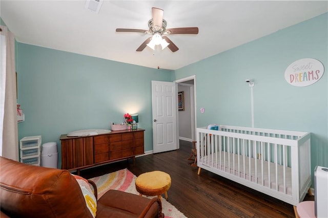 bedroom with wood finished floors, a ceiling fan, and baseboards