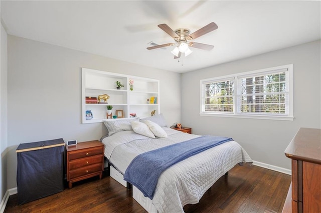 bedroom with ceiling fan, baseboards, and dark wood-style flooring