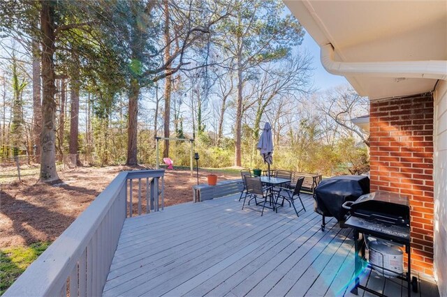 deck featuring a grill and outdoor dining space