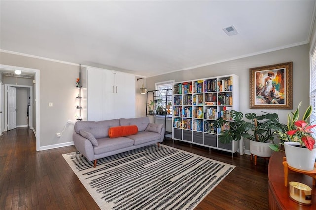 living area with wood-type flooring, visible vents, baseboards, and ornamental molding