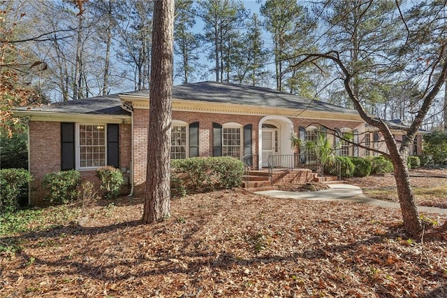 view of front of home featuring covered porch and brick siding