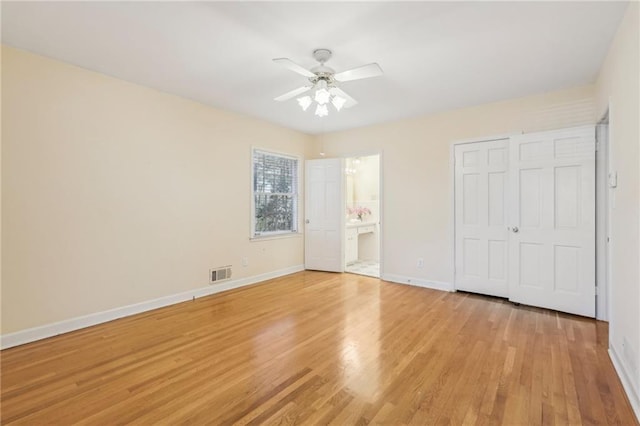 unfurnished bedroom with light wood-type flooring, a closet, visible vents, and baseboards