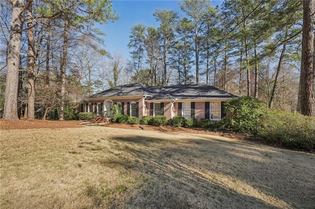 view of front of property featuring a front lawn and brick siding