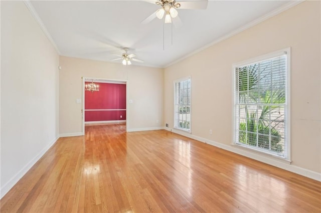 spare room with ornamental molding, light wood-style flooring, baseboards, and ceiling fan with notable chandelier