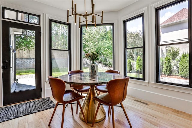 sunroom / solarium with a chandelier and plenty of natural light