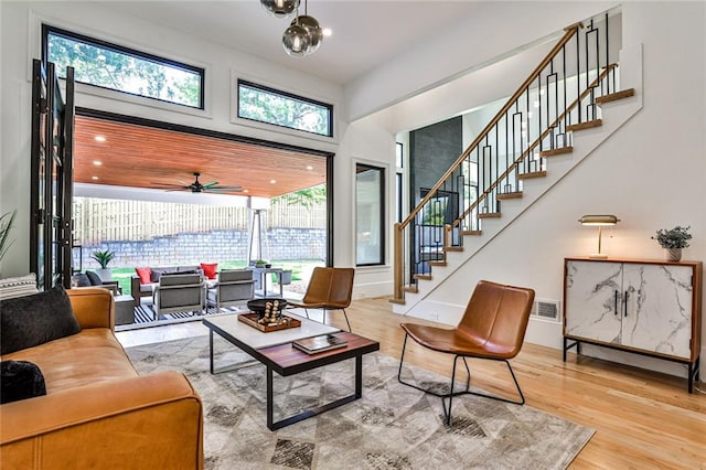 living room with ceiling fan and light hardwood / wood-style floors