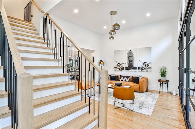 staircase with hardwood / wood-style floors