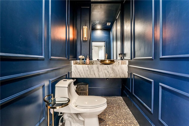 bathroom featuring sink, tile patterned floors, and toilet