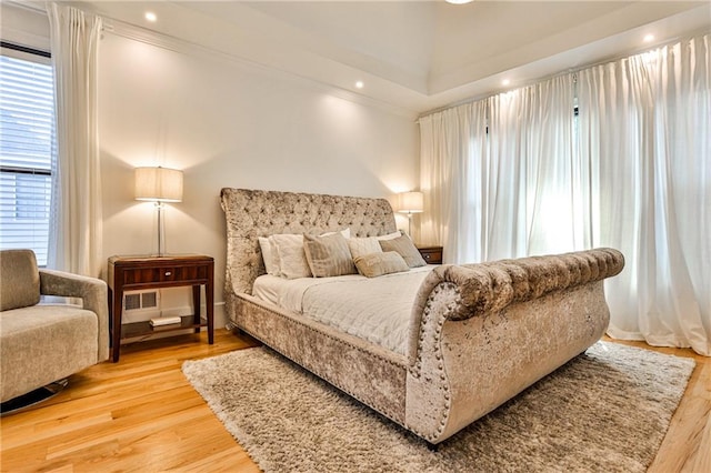 bedroom featuring hardwood / wood-style floors and ornamental molding