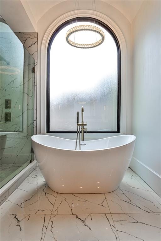 bathroom with a bathing tub and a wealth of natural light