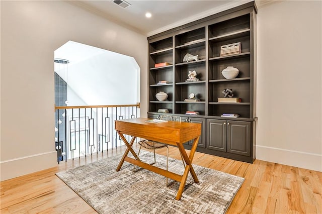 office area featuring light hardwood / wood-style flooring and crown molding