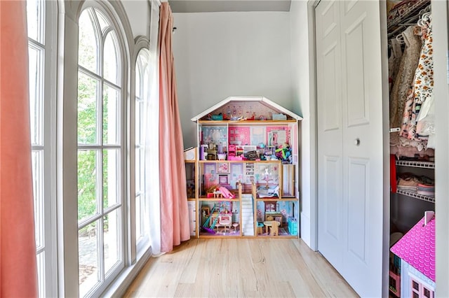 game room with light wood-type flooring and a wealth of natural light