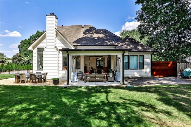 back of property featuring a patio area, ceiling fan, a yard, and outdoor lounge area